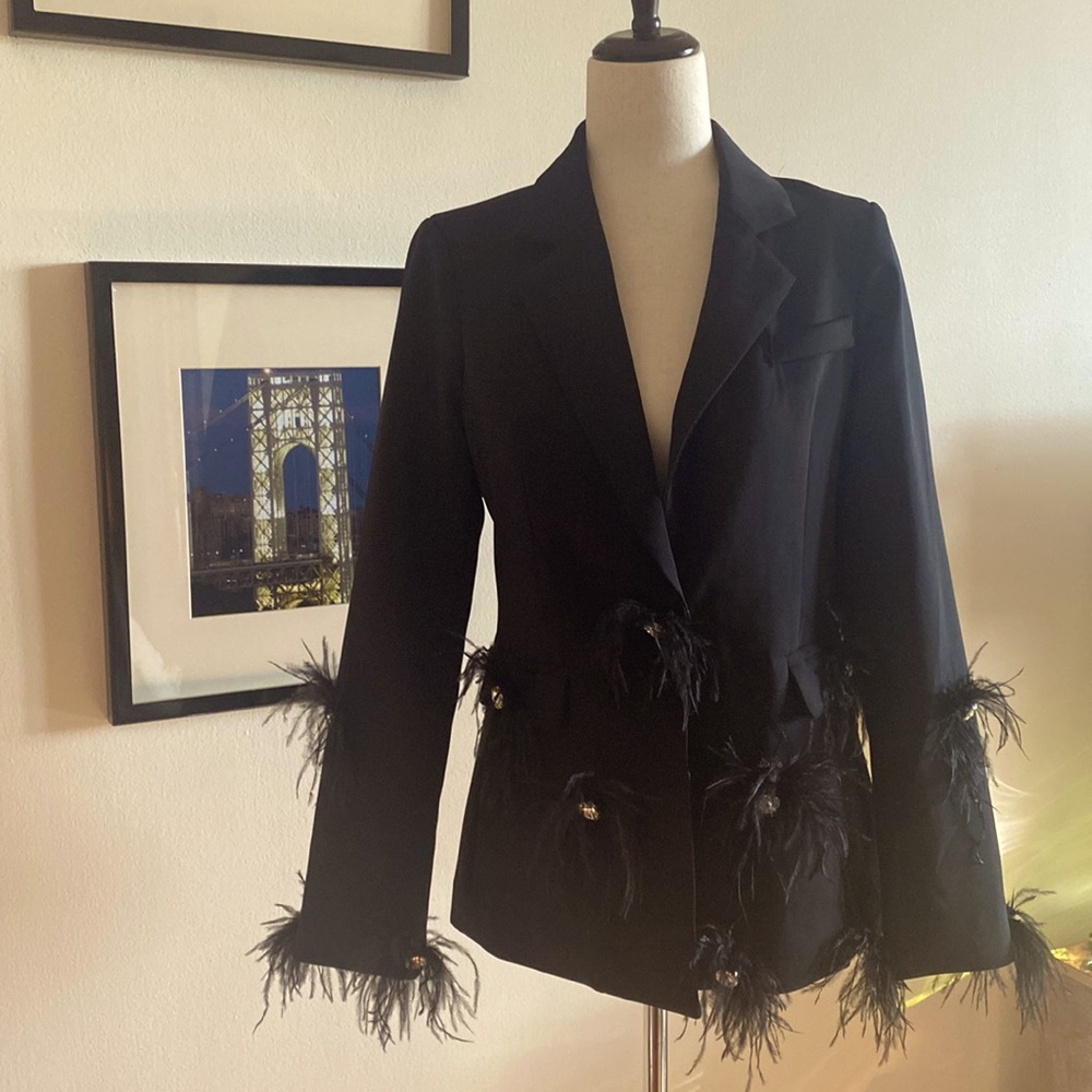 “Mochy” black jacket with feathers.